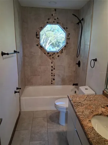 a view of a swimming pool with a patio