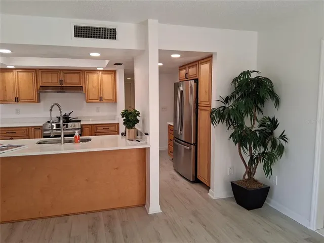 a kitchen with stainless steel appliances granite countertop a sink and cabinets
