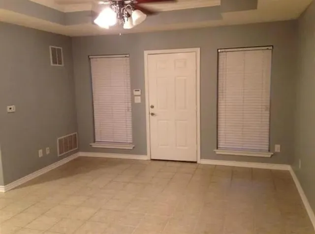 an empty room with windows and closet