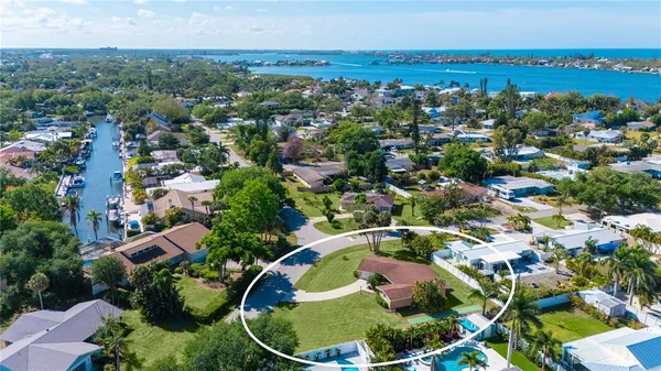 an aerial view of residential houses with outdoor space and swimming pool