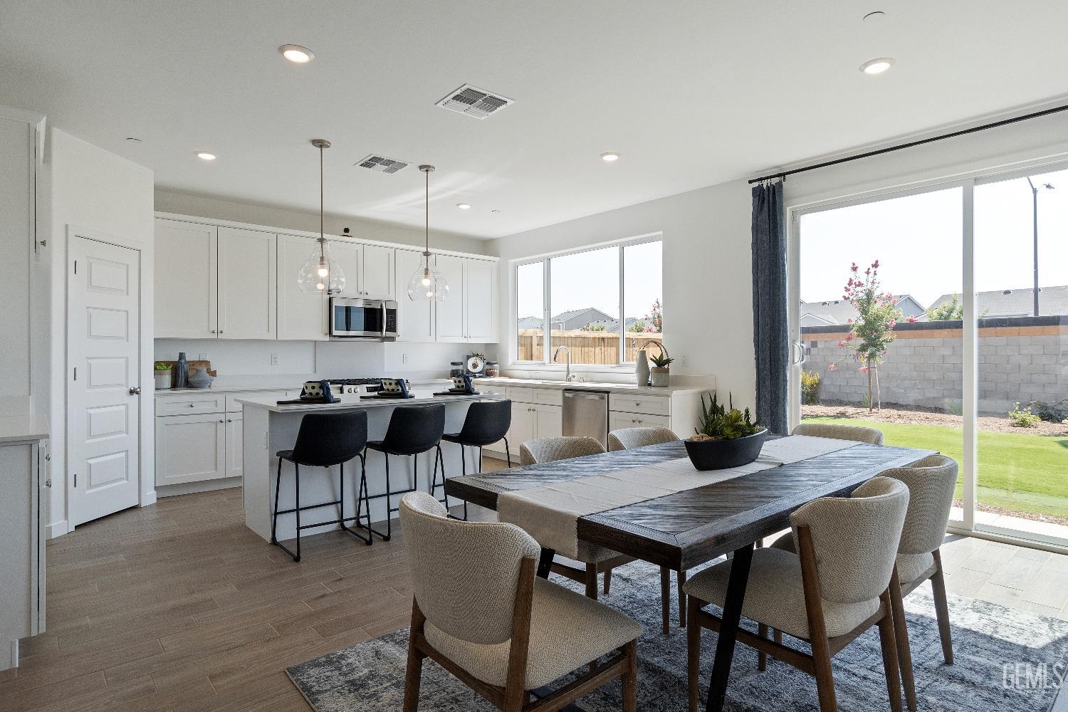 Undisclosed Address Shafter, CA 93263 - Photo 7 of 21 a kitchen with a dining table chairs and white appliances