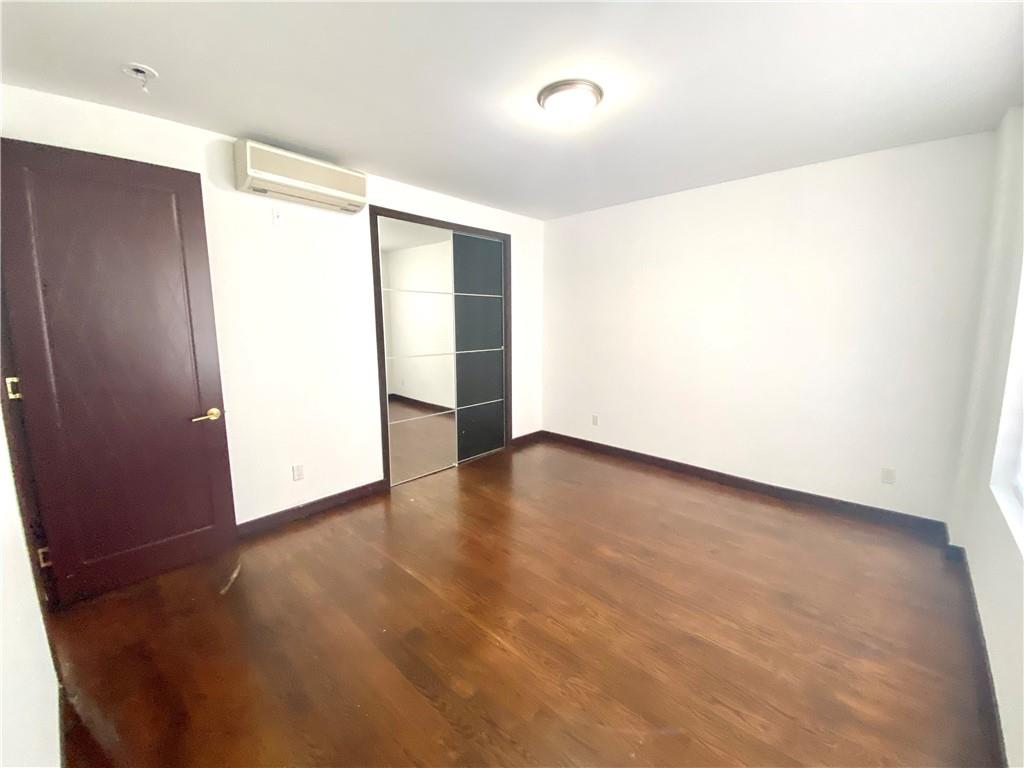 2409 Avenue Z, Unit 202 Brooklyn, NY 11235 - Photo 15 of 26 a view of an empty room with wooden floor and a window