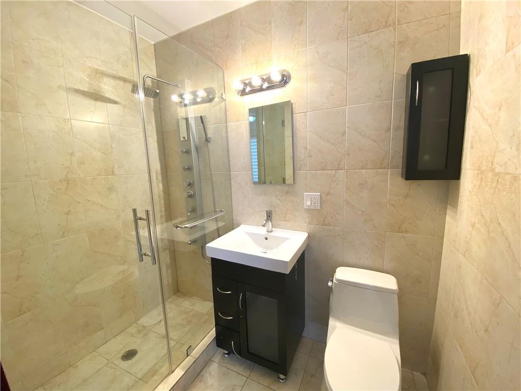 2409 Avenue Z, Unit 202 Brooklyn, NY 11235 - Photo 18 of 26 a bathroom with a sink toilet and shower