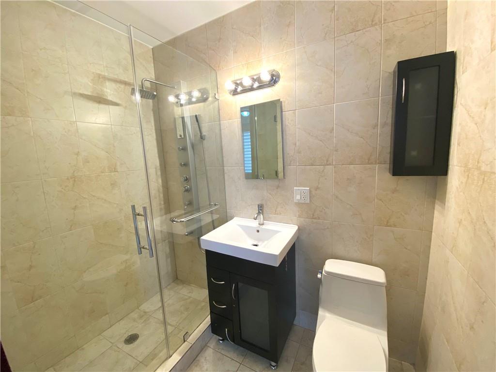 2409 Avenue Z, Unit 202 Brooklyn, NY 11235 - Photo 19 of 26 a bathroom with a sink toilet and shower