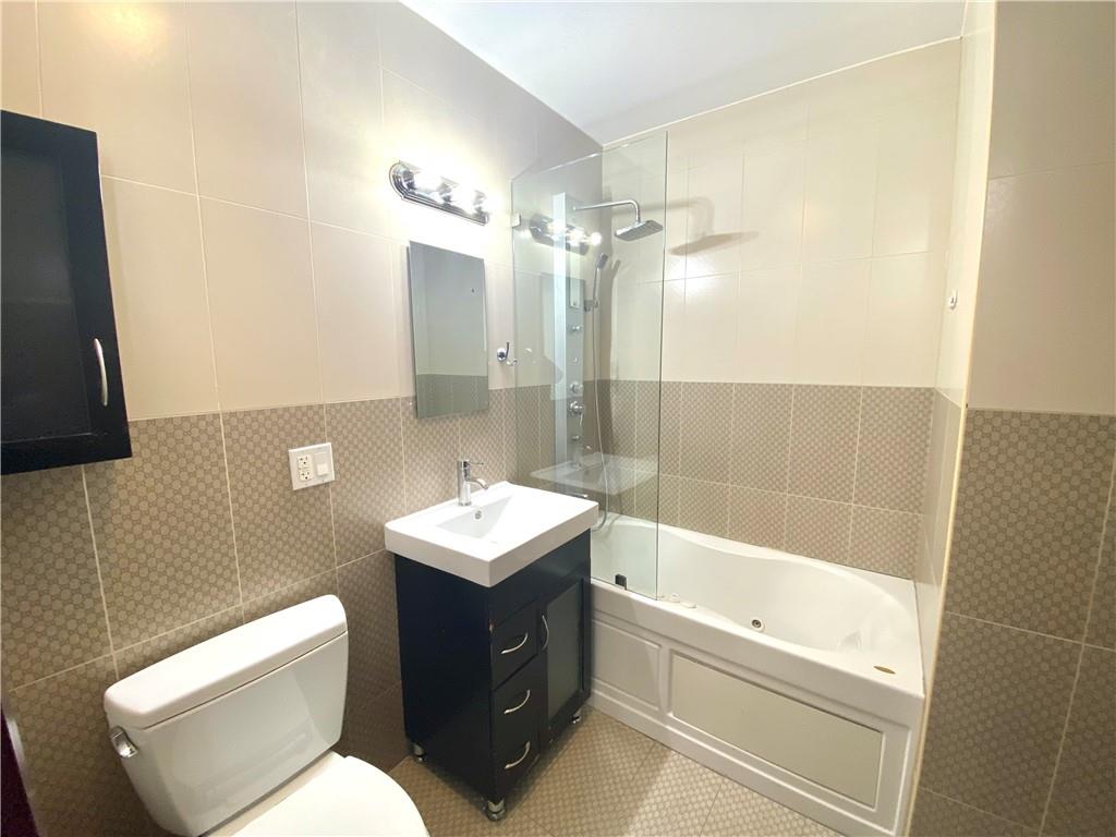 2409 Avenue Z, Unit 202 Brooklyn, NY 11235 - Photo 20 of 26 a bathroom with a toilet a sink and bathtub
