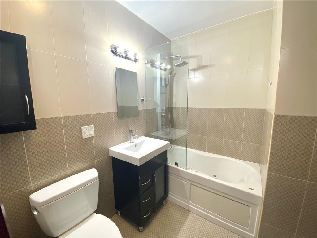 2409 Avenue Z, Unit 202 Brooklyn, NY 11235 - Photo 21 of 26 a bathroom with a toilet a sink and bathtub