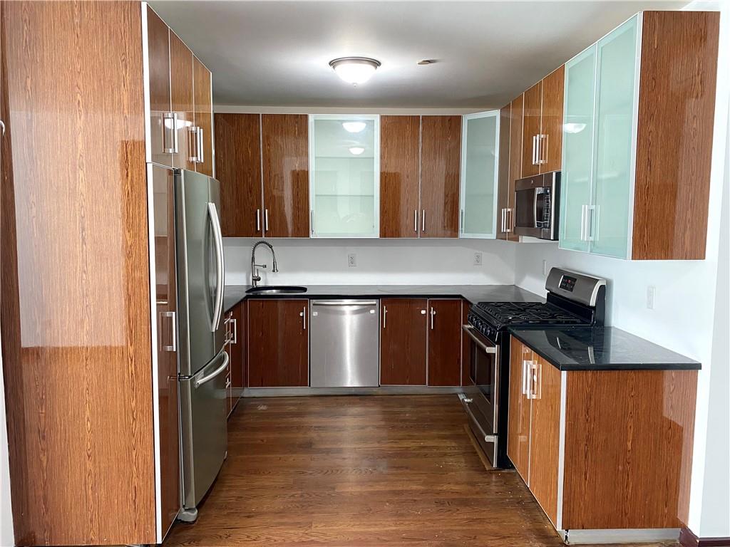 2409 Avenue Z, Unit 202 Brooklyn, NY 11235 - Photo 4 of 26 a kitchen with kitchen island granite countertop a refrigerator and a sink