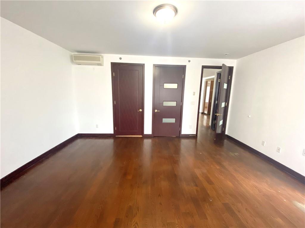 2409 Avenue Z, Unit 202 Brooklyn, NY 11235 - Photo 8 of 26 an empty room with wooden floor and windows