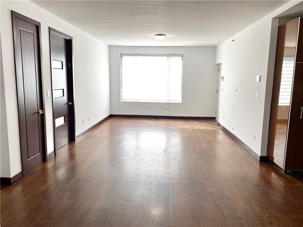 2409 Avenue Z, Unit 202 Brooklyn, NY 11235 - Photo 9 of 26 an empty room with wooden floor and a window