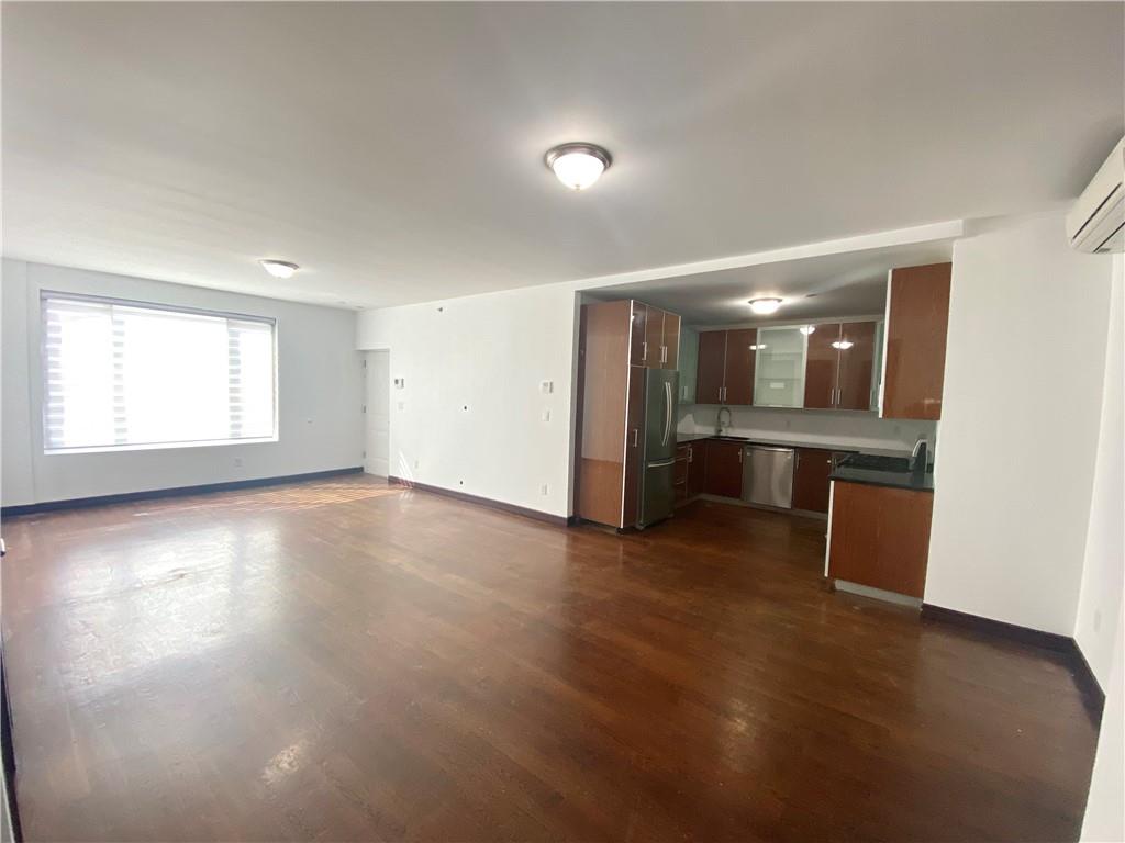 2409 Avenue Z, Unit 202 Brooklyn, NY 11235 - Photo 10 of 26 an empty room with a kitchen and windows