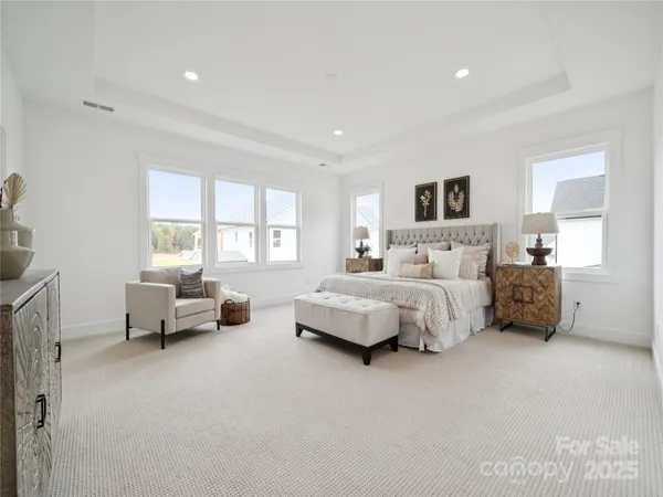 a bedroom with bed couch and window