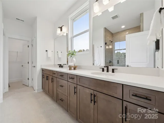 a bathroom with a double vanity sink mirror and double