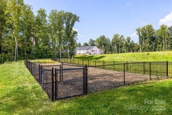 a view of a park with iron fence
