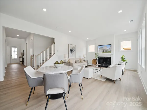 a living room with furniture a fireplace and a table