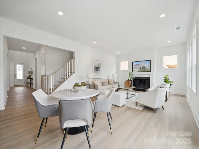 a living room with furniture a fireplace and a table