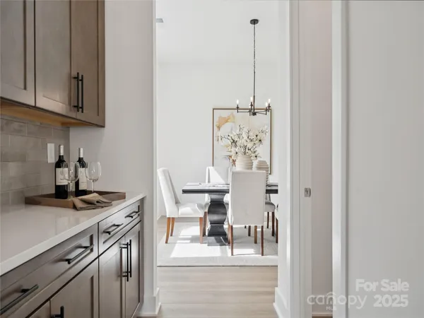a kitchen with stainless steel appliances granite countertop a stove and a white cabinets