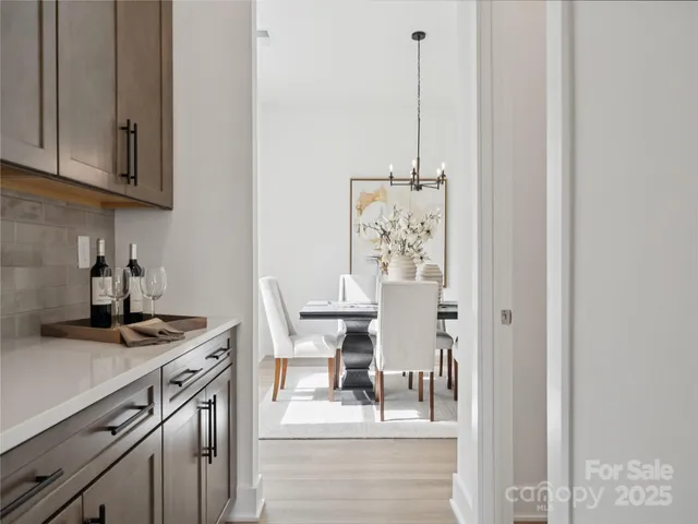 a kitchen with stainless steel appliances granite countertop a stove and a white cabinets