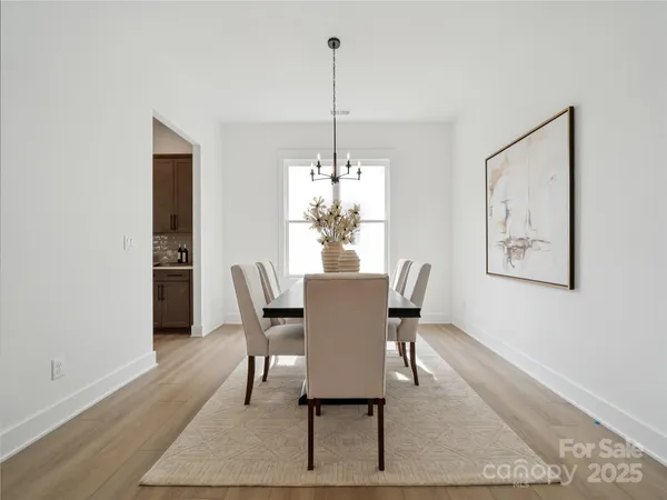 a dining room with furniture a rug and wooden floor