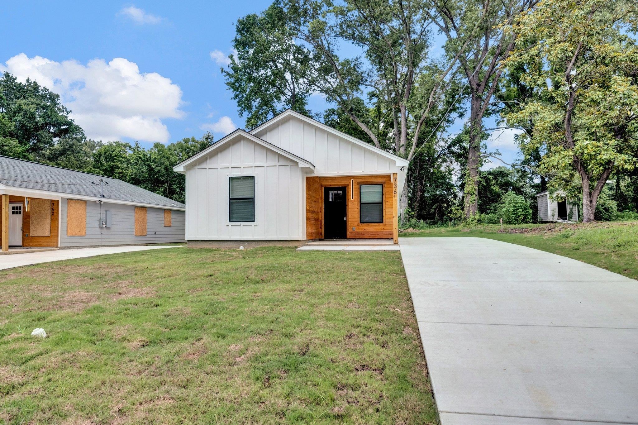 a front view of house with yard and trees