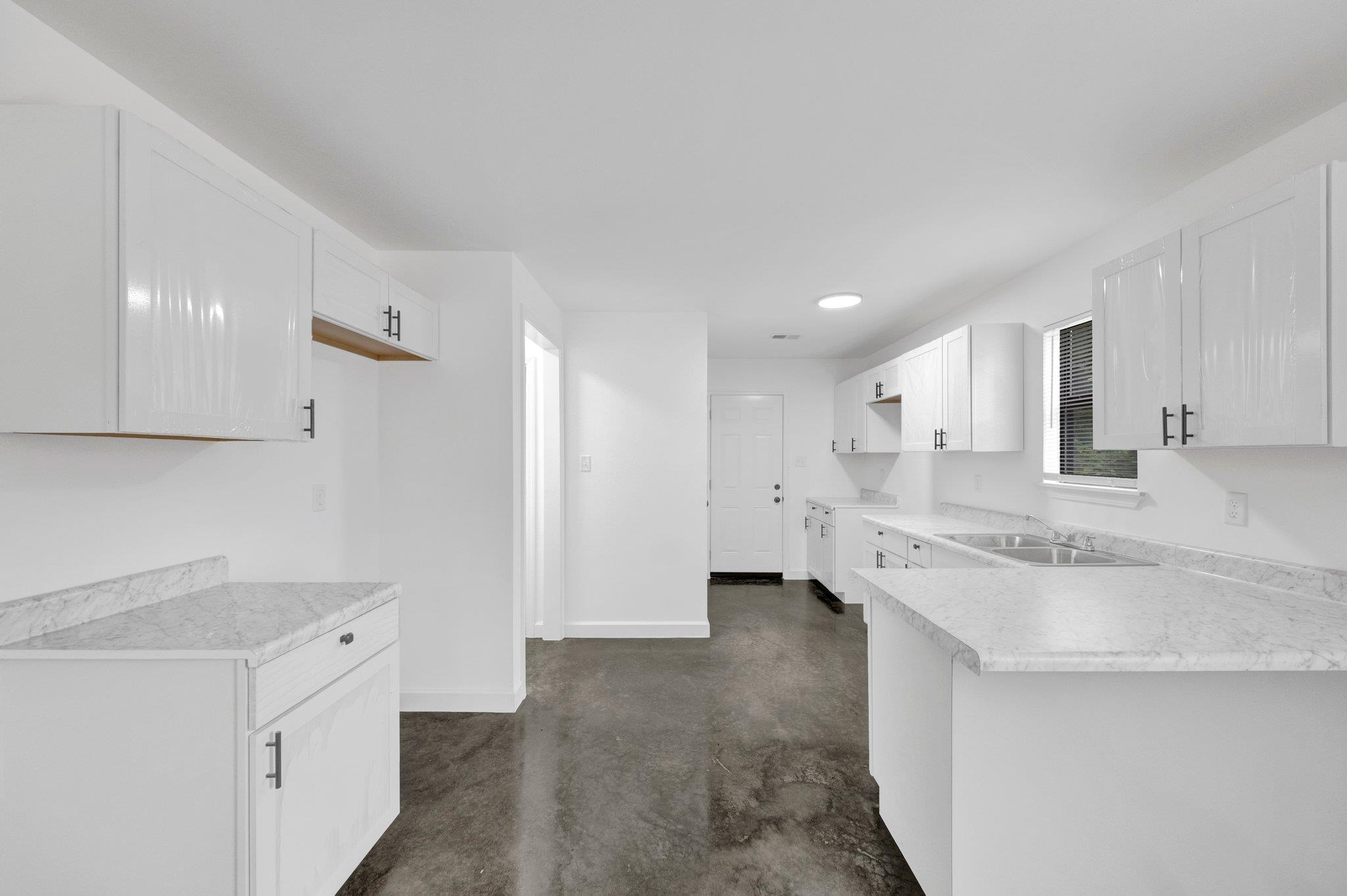 252 Dixie Road Memphis, TN 38109 - Photo 13 of 24 a large white kitchen with a stove a sink dishwasher and a refrigerator with white cabinets