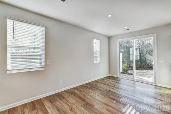 a view of wooden floor and windows in a room