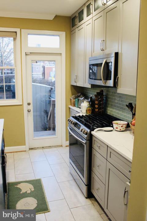 1011 8th Street Northeast Washington, DC 20002 - Photo 17 of 34 a kitchen with stainless steel appliances granite countertop a stove a sink and a microwave