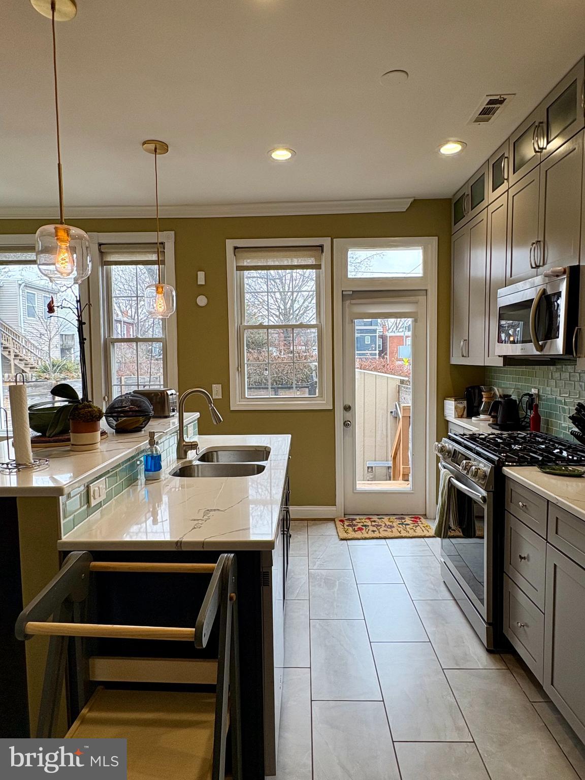 1011 8th Street Northeast Washington, DC 20002 - Photo 20 of 34 a kitchen with stainless steel appliances granite countertop a stove a sink and a refrigerator