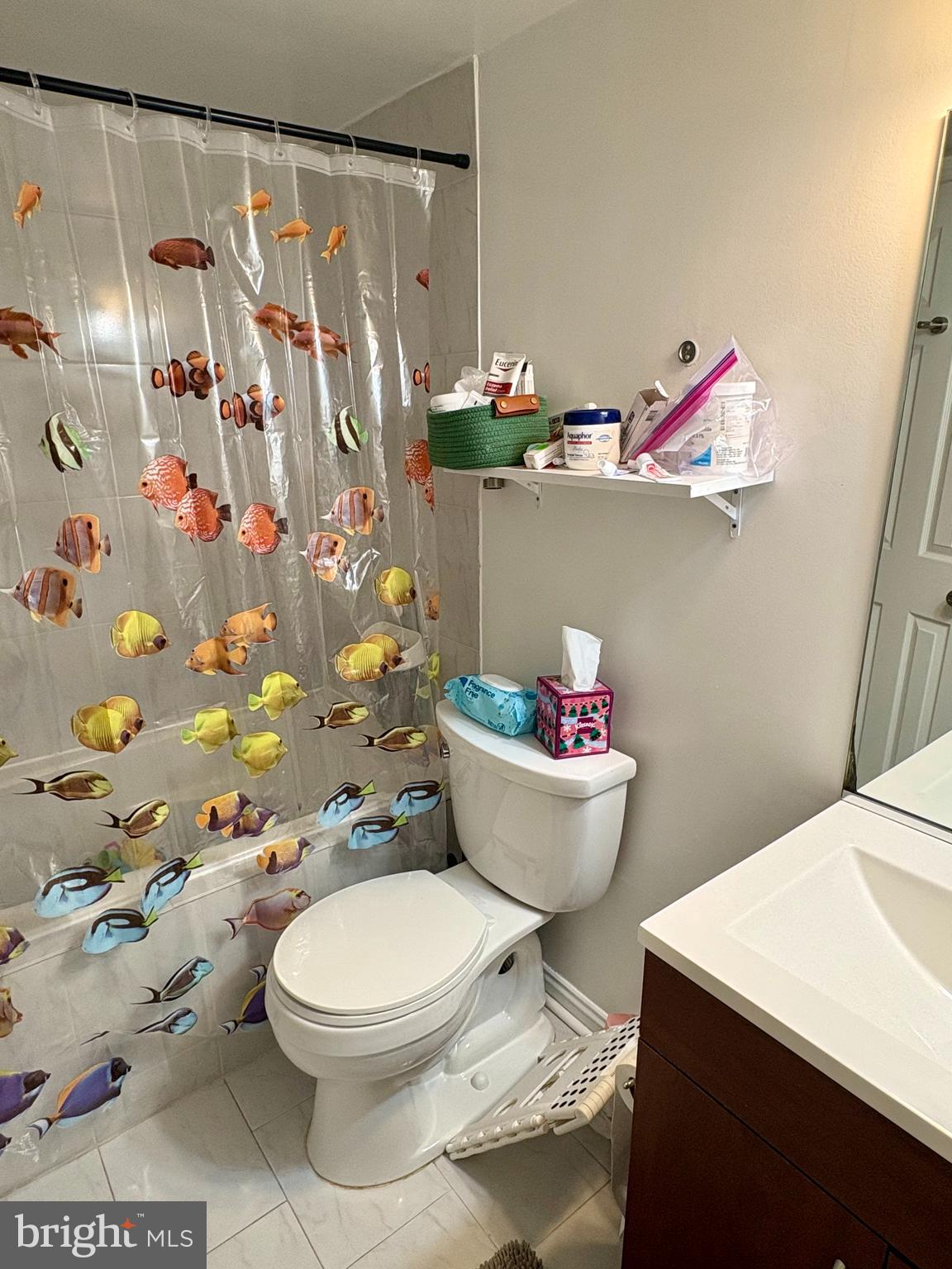 1011 8th Street Northeast Washington, DC 20002 - Photo 29 of 34 a bathroom with a toilet and a shower curtain
