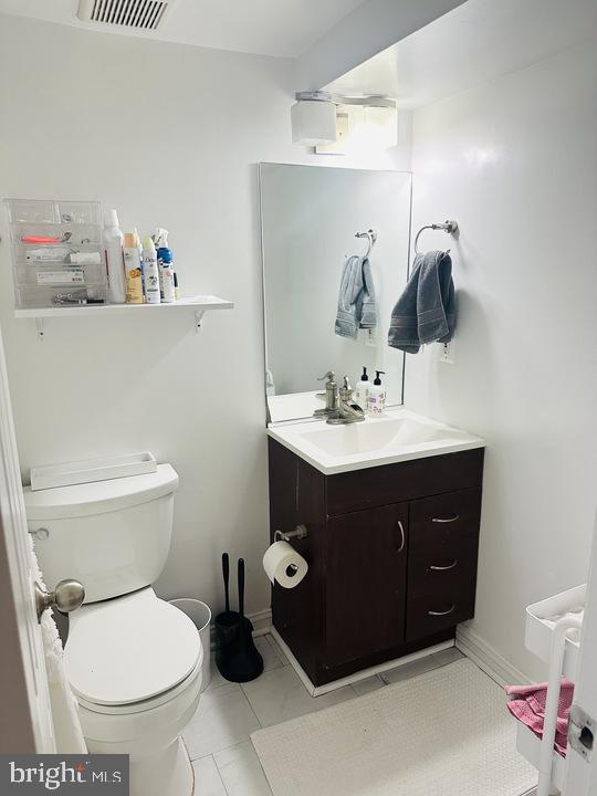 1011 8th Street Northeast Washington, DC 20002 - Photo 33 of 34 a bathroom with a sink vanity mirror and toilet