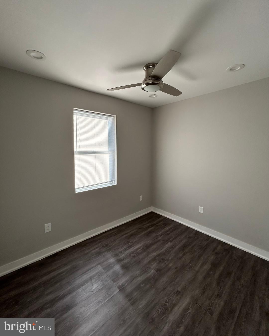 633 Lindley Avenue, Unit 2RF Philadelphia, PA 19120 - Photo 4 of 7 an empty room with wooden floor ceiling fan and windows
