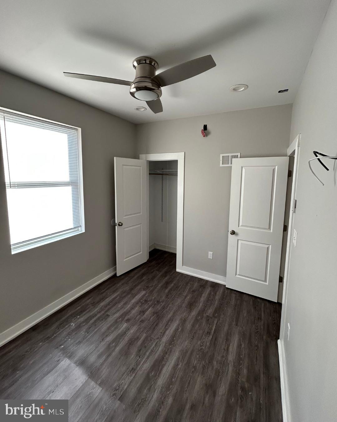 633 Lindley Avenue, Unit 2RF Philadelphia, PA 19120 - Photo 7 of 7 a view of an empty room with wooden floor and a window