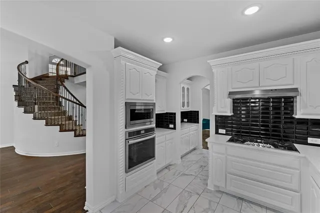 a kitchen with cabinets and stainless steel appliances