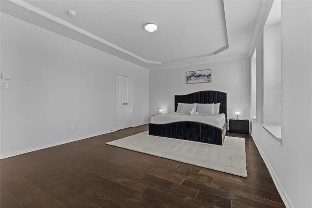 a bedroom with a bed and a night stand