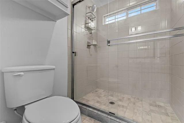 a bathroom with a shower a toilet and a sink