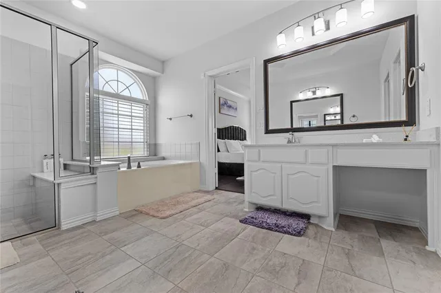 a spacious bathroom with a sink a mirror and a bathtub
