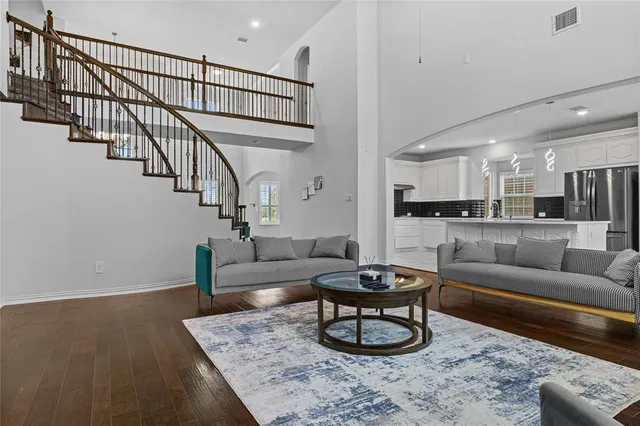 a living room with furniture and a dining table