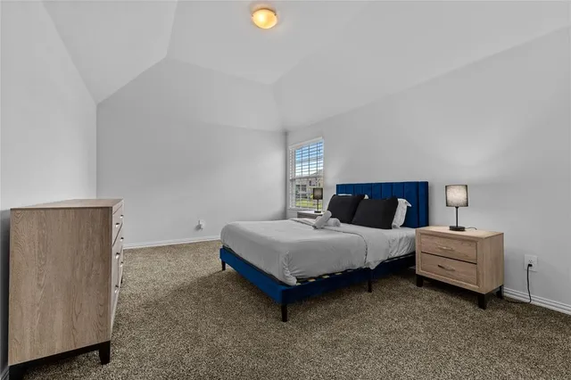 a spacious bedroom with a bed and window