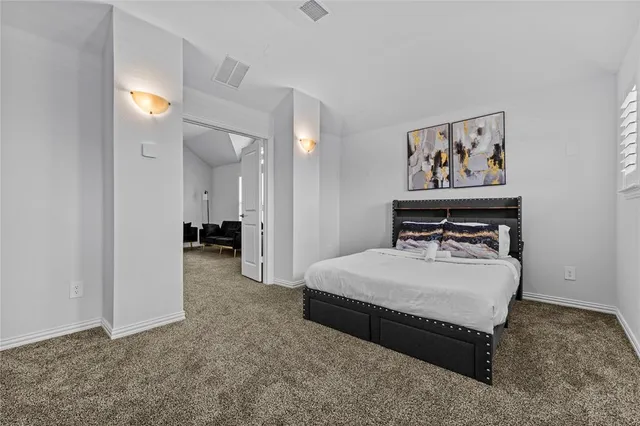 a bed room with a bed and a chandelier