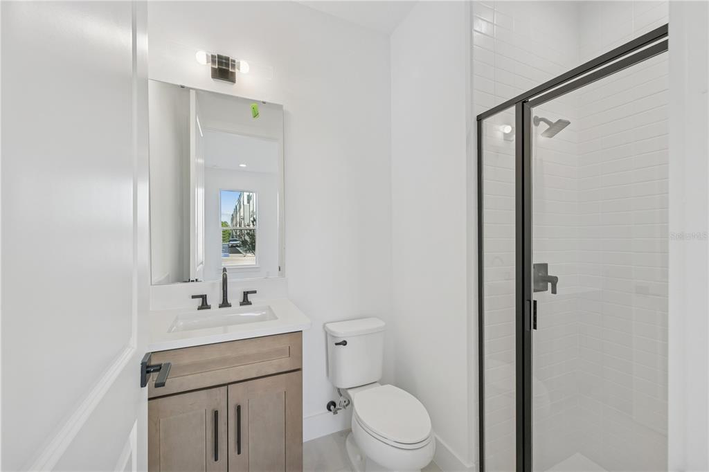 2224 Brix Street Orlando, FL 32804 - Photo 5 of 36 a bathroom with a toilet a sink and mirror