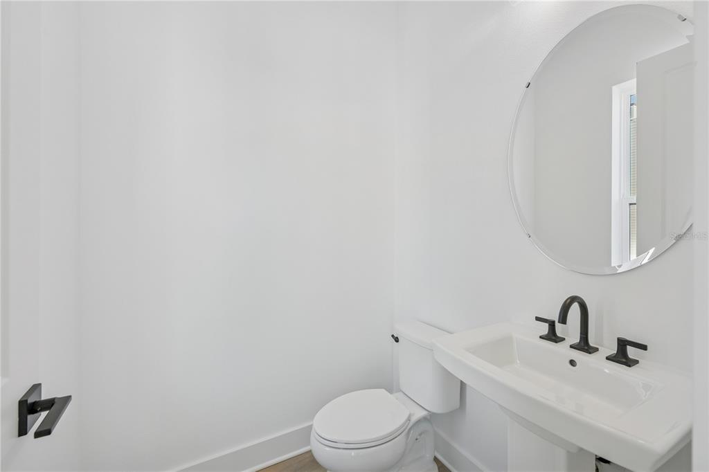 2224 Brix Street Orlando, FL 32804 - Photo 9 of 36 a bathroom with a sink a toilet and mirror