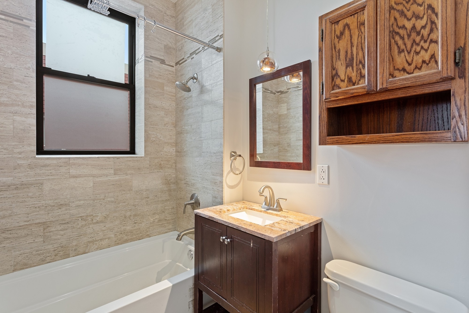 1409 East 62nd Street, Unit 3 Chicago, IL 60637 - Photo 8 of 10 a bathroom with a granite countertop sink and a bathtub