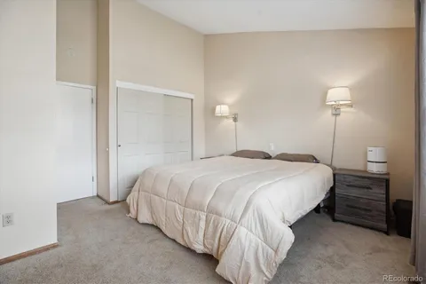 a bedroom with a bed and a night stand