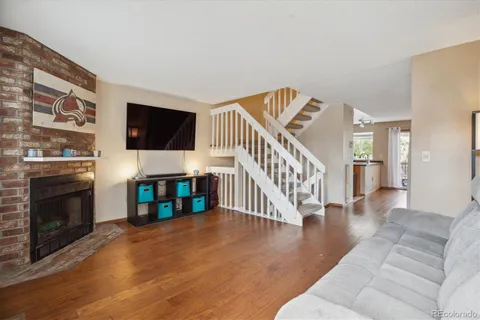 a living room with fireplace furniture and a flat screen tv