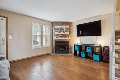 a view of a livingroom with furniture and a fireplace