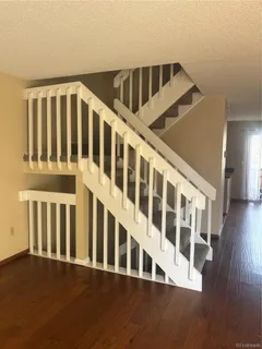 a view of staircase with lots of wooden floor and windows