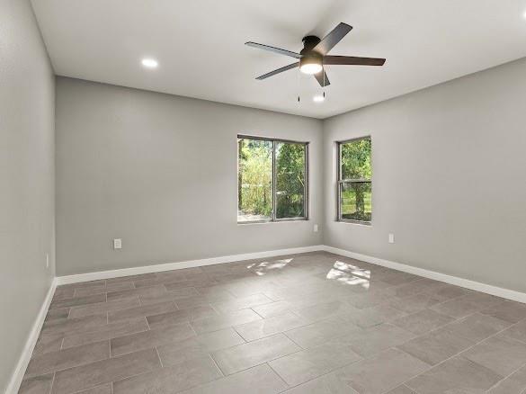 1301 East 9th Street Mount Pleasant, TX 75455 - Photo 12 of 26 an empty room with windows and ceiling fan