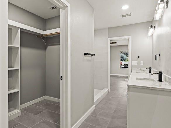 1301 East 9th Street Mount Pleasant, TX 75455 - Photo 16 of 26 a bathroom with a sink and a mirror