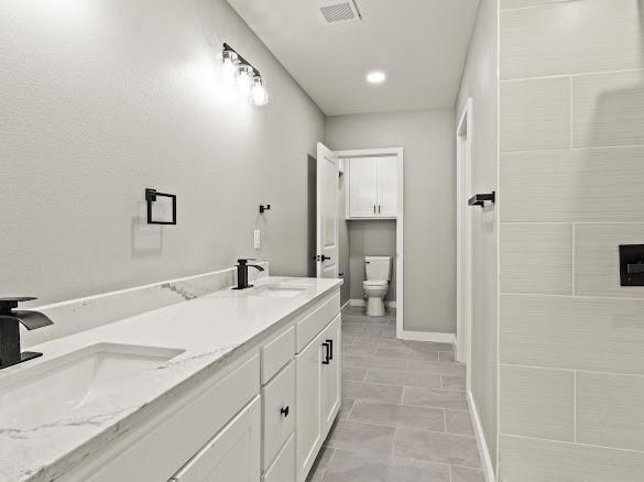 1301 East 9th Street Mount Pleasant, TX 75455 - Photo 17 of 26 a spacious bathroom with a granite countertop sink a mirror and a