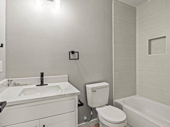 1301 East 9th Street Mount Pleasant, TX 75455 - Photo 19 of 26 a bathroom with a sink a toilet and shower