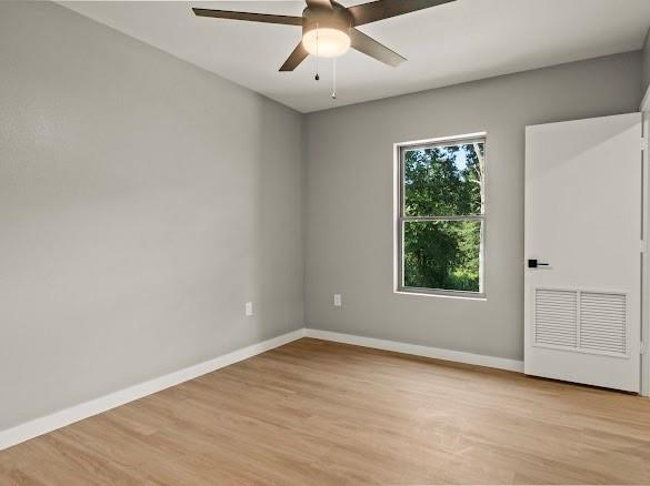1301 East 9th Street Mount Pleasant, TX 75455 - Photo 22 of 26 an empty room with wooden floor and windows